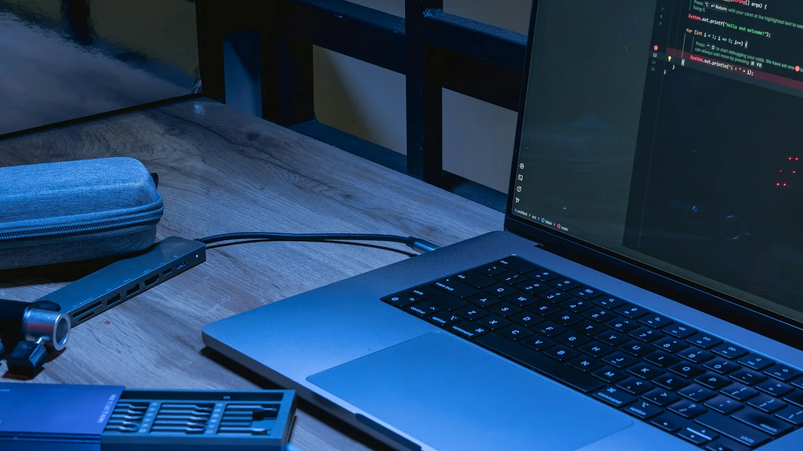 Laptop displaying source code in a web engineering workspace